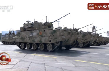 Κινέζοι στρατιώτες σπρώχνουν τεθωρακισμένο που χάλασε στη μέση της παρέλασης
